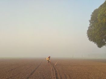 A farmer prepares the field for growing crops on a winter morning.