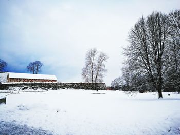 Snow covered landscape against sky