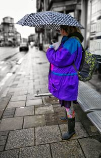 Rear view of boy walking in city