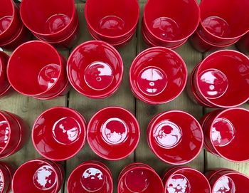 Full frame shot of empty red bowls on table