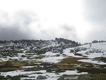 Scenic view of snow covered mountains against sky