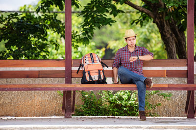 Man sitting on bench in park
