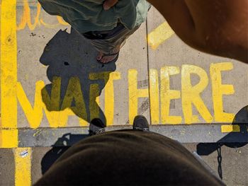 Low section of people standing on street