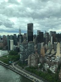 View of cityscape against cloudy sky