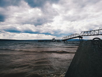 Bridge over sea against sky