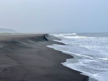 Scenic view of beach against clear sky