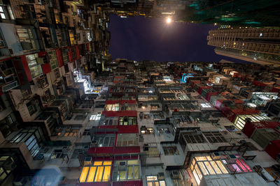 Low angle view of illuminated buildings in city at night