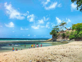 Scenic view of beach against cloudy sky
