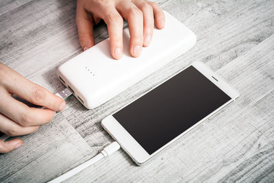 High angle view of person using smart phone on table
