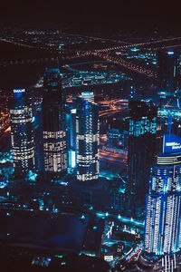 Aerial view of illuminated buildings in city at night