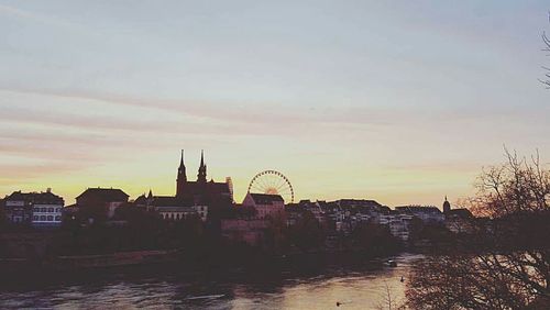 Buildings against sky at sunset