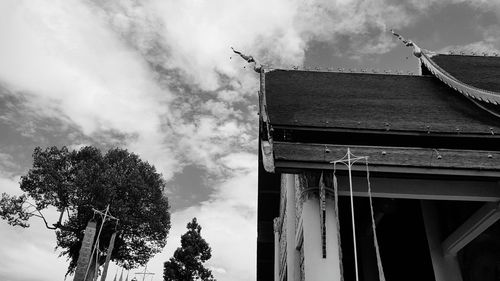 Low angle view of building against cloudy sky