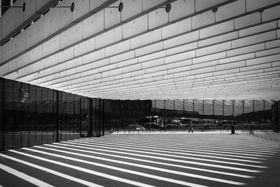 Empty road amidst buildings in city
