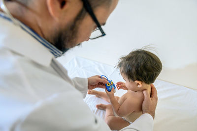 Doctor observing a one-year-old baby