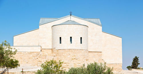 Low angle view of building against clear blue sky