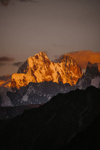 Scenic view of snowcapped mountains against sky during sunset