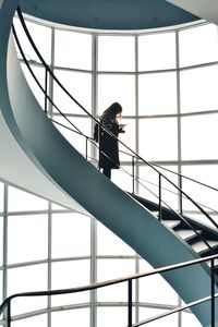 Low angle view of woman standing on staircase