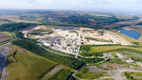 Aerial view of agricultural landscape against cloudy sky