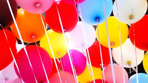 Low angle view of balloons flying