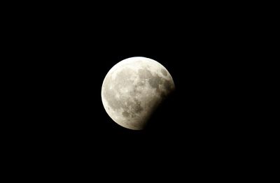 Low angle view of moon against clear sky at night