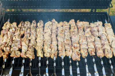 Panoramic shot of meat on barbecue grill