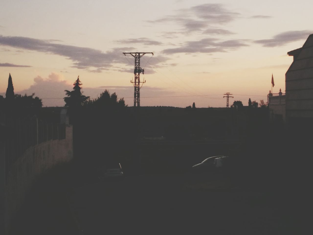 silhouette, sunset, sky, power line, electricity pylon, building exterior, built structure, architecture, electricity, cloud - sky, cable, power supply, cloud, connection, dusk, dark, outdoors, house, tree, nature