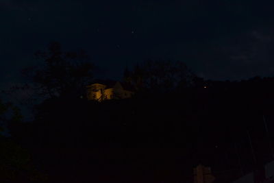 Silhouette trees against sky at night