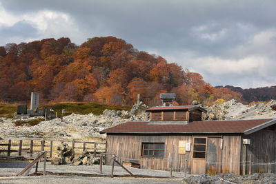 Trees and buildings against sky during autumn