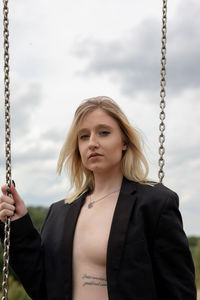 Portrait of a beautiful young woman holding camera