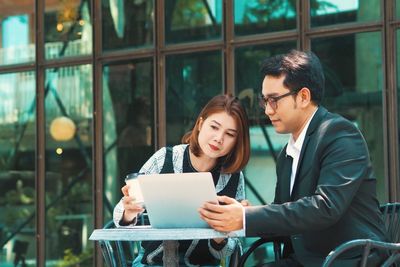 Young woman using laptop at office