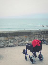 Bicycles on beach against sky