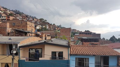 Buildings in town against sky