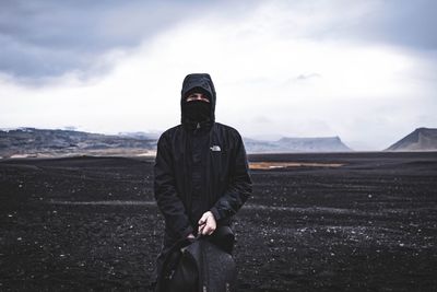 Man standing on mountain against sky