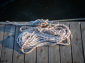 High angle view of rope tied on pier