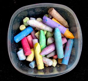 Close-up of crayons in container on bowl