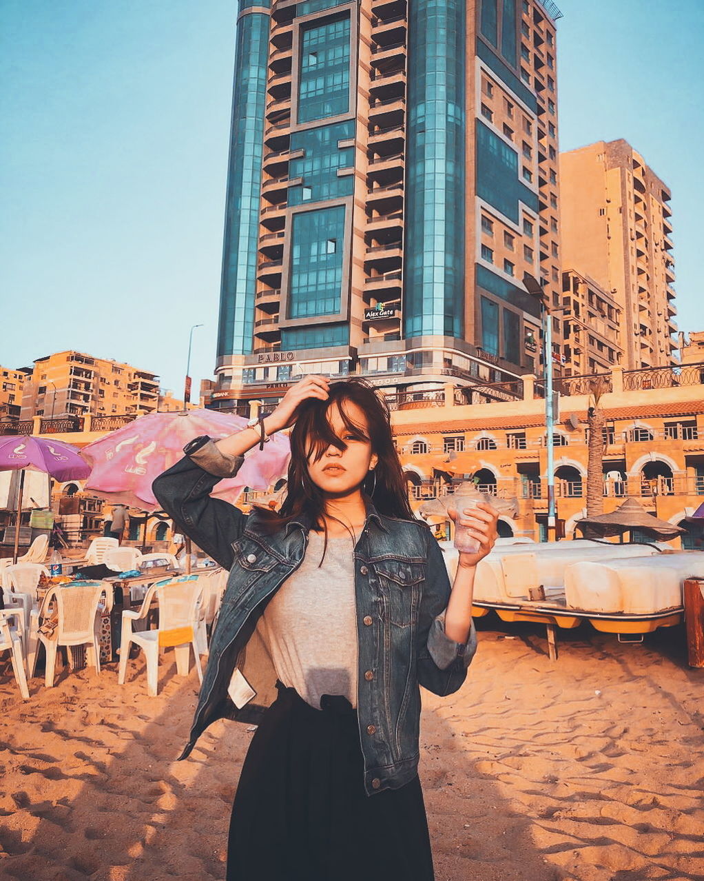 architecture, built structure, real people, lifestyles, building exterior, city, standing, leisure activity, young adult, young women, front view, people, smiling, three quarter length, women, casual clothing, sky, portrait, emotion, incidental people, outdoors, skyscraper, office building exterior