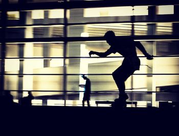 Side view of a man jumping against blurred background