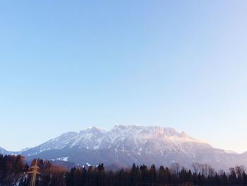 Scenic view of snowcapped mountains against clear blue sky