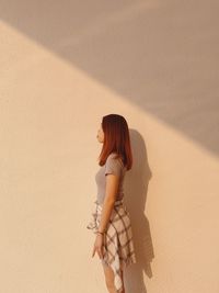 High angle view of woman standing on sand