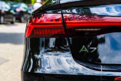 Close-up of red car on street