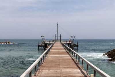 Pier over sea against sky