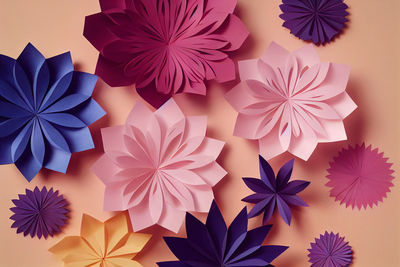 Colorful paper cut flowers on yellow background