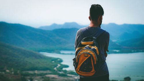 Rear view of man looking at mountains