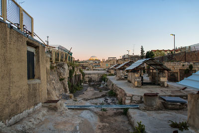 Old buildings in town against clear sky