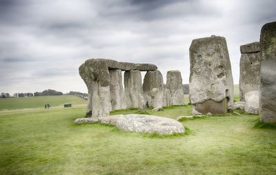 Stone structure in park against cloudy sky