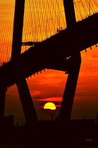 Low angle view of silhouette bridge against sky during sunset