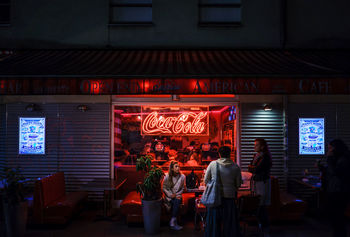 PEOPLE STANDING OUTSIDE RESTAURANT