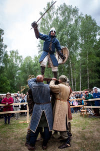 People in traditional clothing against sky