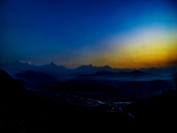 Scenic view of silhouette mountains against sky at night