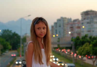 Portrait of a beautiful young woman in city